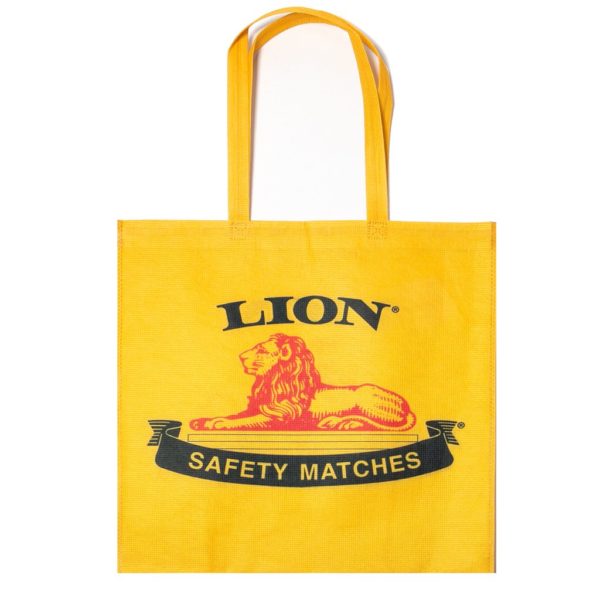 A yellow shopping bag with the print 'LION SAFETY MATCHES' in a bold font, featuring a graphic of a lion.