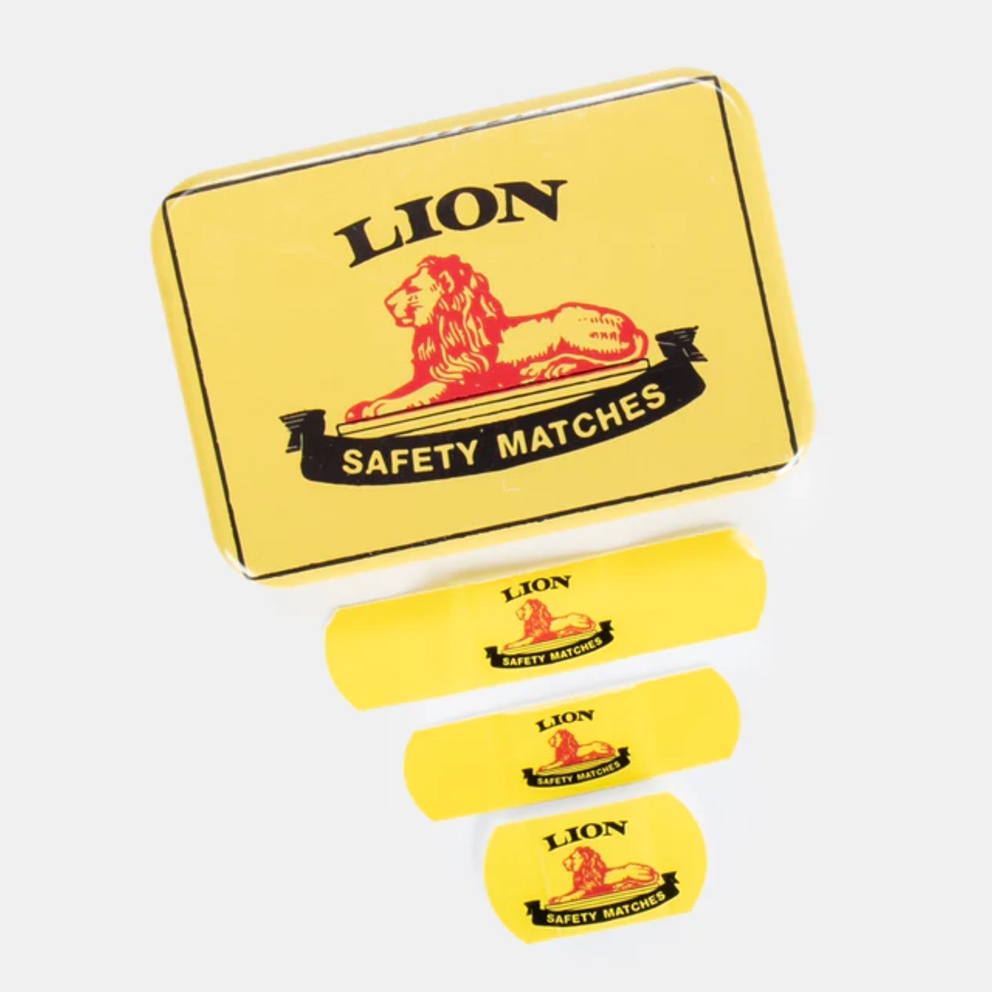 Yellow box of Lion safety matches with four match sticks on a white background