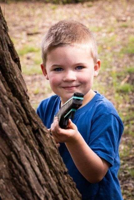 Boy playing with toy gun