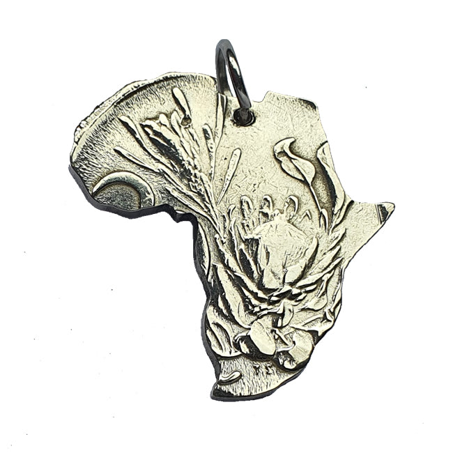 A silver pendant in the shape of the king protea flower, with a textured surface and a metallic finish.