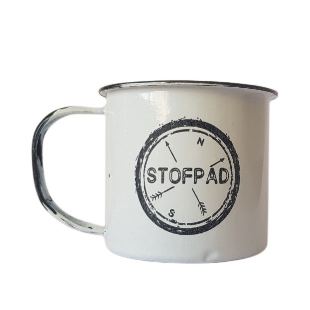 A white enamel mug with a black design, featuring a compass and the text 'STOFPAD'.